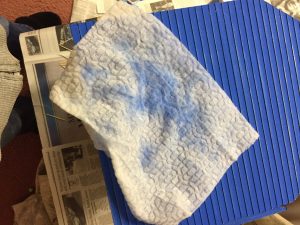 A picture of the dusting cloth with a lot of paint on it.