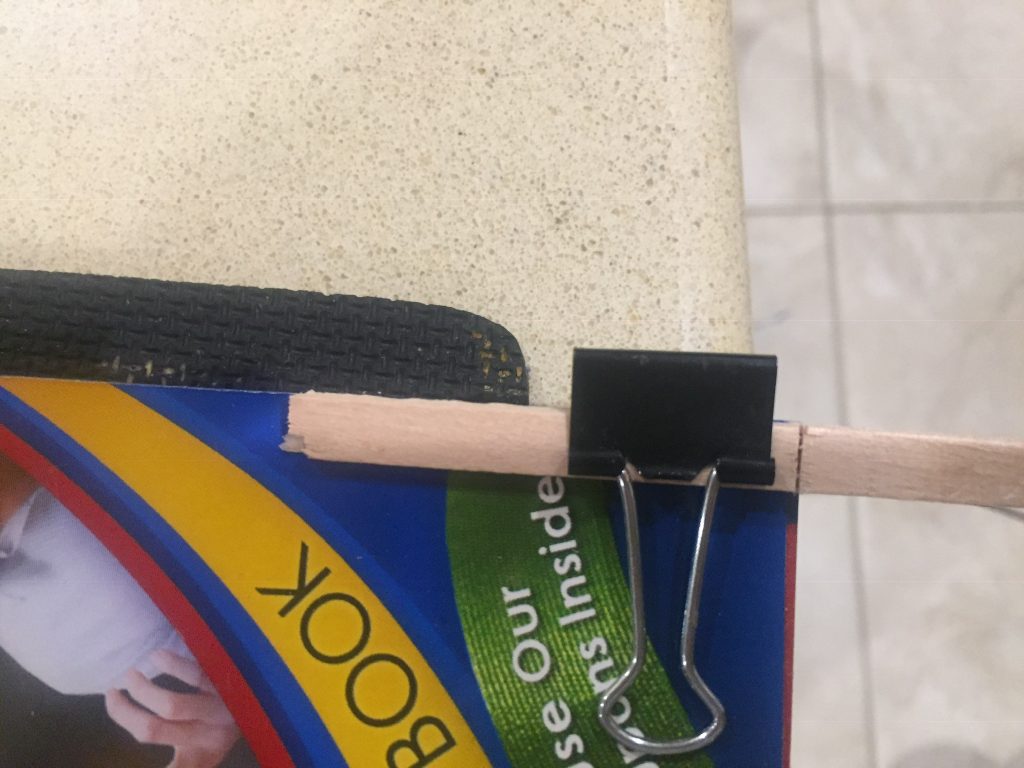 A picture of a paper clip I used as a clamp on the phone book